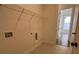 The laundry room features tile floors and a storage rack at 515 Cottage Creek Dr, Cumming, GA 30040