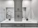 A spacious bathroom with double sinks, large mirrors, and gray cabinetry at 8981 Callaway Dr, Winston, GA 30187