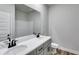 Bathroom featuring double vanity sinks, granite countertops, and modern fixtures at 8981 Callaway Dr, Winston, GA 30187