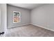 Cozy bedroom featuring a neutral carpet, light gray walls, and a view of the exterior at 8981 Callaway Dr, Winston, GA 30187