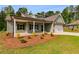 Charming one-story home features a covered porch, two-car garage, and verdant landscaping at 8981 Callaway Dr, Winston, GA 30187