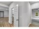 Hallway with a view of a powder room, a bedroom, and laminate floors at 8981 Callaway Dr, Winston, GA 30187