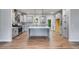 Modern kitchen featuring gray cabinetry, a large island, stainless appliances, and wood-look floors at 8981 Callaway Dr, Winston, GA 30187