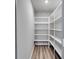 Walk-in pantry with ample shelving and laminate flooring, providing lots of room for storage at 8981 Callaway Dr, Winston, GA 30187