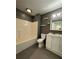 Updated bathroom with white vanity and grey tile at 420 Old Holcomb Bridge Rd, Roswell, GA 30076