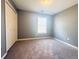 Well-lit bedroom with neutral gray walls and carpeting at 420 Old Holcomb Bridge Rd, Roswell, GA 30076