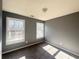 Bright bedroom with gray walls and carpet, featuring two large windows at 420 Old Holcomb Bridge Rd, Roswell, GA 30076
