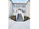 Two-story townhome with gray siding, gray stairs, and landscaping at 420 Old Holcomb Bridge Rd, Roswell, GA 30076
