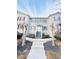 Two-story townhome with gray siding, gray stairs, and landscaping at 420 Old Holcomb Bridge Rd, Roswell, GA 30076