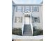 Two-story townhome with gray siding, gray stairs, and landscaping at 420 Old Holcomb Bridge Rd, Roswell, GA 30076