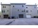 Rear view of townhouses with attached garages and ample parking at 420 Old Holcomb Bridge Rd, Roswell, GA 30076