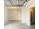 Garage interior with ceiling fan, gray flooring and a decorative stone wall at 420 Old Holcomb Bridge Rd, Roswell, GA 30076