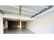 Garage interior with ceiling fan, gray flooring and a decorative stone wall at 420 Old Holcomb Bridge Rd, Roswell, GA 30076