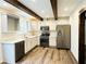 Modern kitchen with white cabinets, stainless steel appliances, and wood beams at 420 Old Holcomb Bridge Rd, Roswell, GA 30076