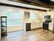 Modern kitchen with white cabinets, stainless steel appliances, and wood beams at 420 Old Holcomb Bridge Rd, Roswell, GA 30076