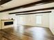 Spacious living room with hardwood floors, exposed beams, and a fireplace at 420 Old Holcomb Bridge Rd, Roswell, GA 30076
