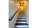 Modern staircase with dark wood steps and a simple handrail at 420 Old Holcomb Bridge Rd, Roswell, GA 30076