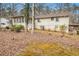 The backyard shows a view of the home with a sunroom, carport, and mature landscaping at 490 Dorsey Road Rd, Hampton, GA 30228