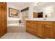 Bright bathroom featuring a soaking tub, tiled floors and a vanity with wood cabinets at 490 Dorsey Road Rd, Hampton, GA 30228