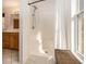 Bathroom featuring a walk-in shower with white curtain, wood bench, and a wood vanity at 490 Dorsey Road Rd, Hampton, GA 30228