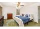 Bedroom with vintage ceiling fan, two dressers, bed with throw pillows and window looking outside at 490 Dorsey Road Rd, Hampton, GA 30228