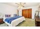 Bedroom with a vintage ceiling fan, closet and dark wood furniture at 490 Dorsey Road Rd, Hampton, GA 30228