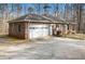 Spacious brick home featuring an attached garage and concrete driveway in a wooded setting at 490 Dorsey Road Rd, Hampton, GA 30228