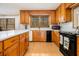Well-equipped kitchen with wood cabinets, modern appliances, and a view of surrounding natural lighting at 490 Dorsey Road Rd, Hampton, GA 30228