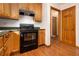 Classic kitchen with wood cabinets and modern black appliances, ready for culinary adventures at 490 Dorsey Road Rd, Hampton, GA 30228