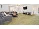 Spacious living room featuring a comfortable gray sofa, television, and a large window at 490 Dorsey Road Rd, Hampton, GA 30228