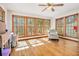 Bright sun room with hardwood floors, multiple windows offering beautiful views of the surrounding nature at 490 Dorsey Road Rd, Hampton, GA 30228