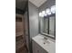 Bathroom with vanity, mirror, and access to bathtub at 10411 Ivygate Ter, Jonesboro, GA 30238