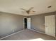 Spacious bedroom with neutral gray walls, carpet flooring, ceiling fan, and ample closet space at 10411 Ivygate Ter, Jonesboro, GA 30238