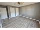 Bright bedroom with ceiling fan, wood-look flooring, and double closets at 10411 Ivygate Ter, Jonesboro, GA 30238
