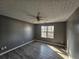Well-lit bedroom with ceiling fan and wood-look flooring at 10411 Ivygate Ter, Jonesboro, GA 30238