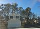 Two-story house with a white garage door and pine trees at 10411 Ivygate Ter, Jonesboro, GA 30238