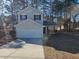 Two-story house, tan siding, white garage door, and sunny day at 10411 Ivygate Ter, Jonesboro, GA 30238