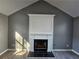 White fireplace with gray wall and wood-look floors at 10411 Ivygate Ter, Jonesboro, GA 30238