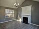 Living room with fireplace, gray walls, and wood-look floors at 10411 Ivygate Ter, Jonesboro, GA 30238