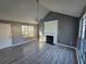 Living room with fireplace, gray walls, and wood-look floors at 10411 Ivygate Ter, Jonesboro, GA 30238