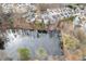 Aerial view of homes near a pond in a quiet residential neighborhood at 135 Cessna Dr, Canton, GA 30114