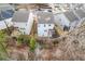 Aerial view of houses situated along a pond, offering tranquil backyard views at 135 Cessna Dr, Canton, GA 30114