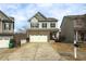 Two-story home with a white garage door, welcoming porch and landscaping at 135 Cessna Dr, Canton, GA 30114