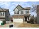 Two-story home with a white garage door and manicured lawn at 135 Cessna Dr, Canton, GA 30114