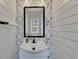 Small powder room with white vanity and floral wallpaper at 135 Cessna Dr, Canton, GA 30114