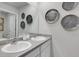 Modern bathroom with double sinks and decorative wall art at 529 Vervain Drive, Locust Grove, GA 30248