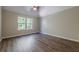 Spacious bedroom with wood-look floors and a ceiling fan at 5590 Vickery Cir, Cumming, GA 30040