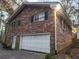 Brick garage with a white door, attached to the house at 730 Ponderosa Ct, Fayetteville, GA 30214