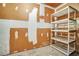 Unfinished basement with ample storage space, shelving, and concrete flooring awaiting your creative touch at 104 Woodhaven Way, Alpharetta, GA 30009