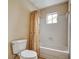 Functional bathroom featuring a shower-tub combo, neutral color scheme, and all essential fixtures at 104 Woodhaven Way, Alpharetta, GA 30009
